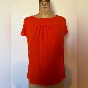 Anthropologie Maeve orange blouse with button sleeves and little dot design